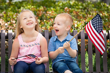 Image showing Young Sister and Brother Comparing Each Others American Flag Siz