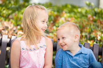 Image showing Young Sister and Brother Having Fun On The Bench At The Park