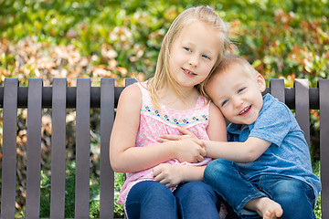 Image showing Young Sister and Brother Having Fun On The Bench At The Park