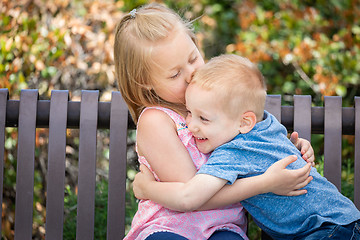 Image showing Young Sister and Brother Having Fun On The Bench At The Park