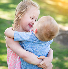 Image showing Young Brother and Sister Hugging At The Park