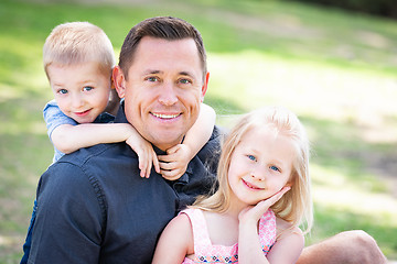 Image showing Young Caucasian Dad, Son and Daughter Having Fun In The Park