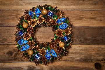 Image showing Christmas wreath on wooden background