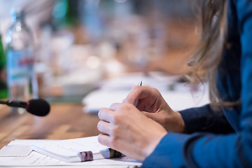 Image showing close up of business people taking notes