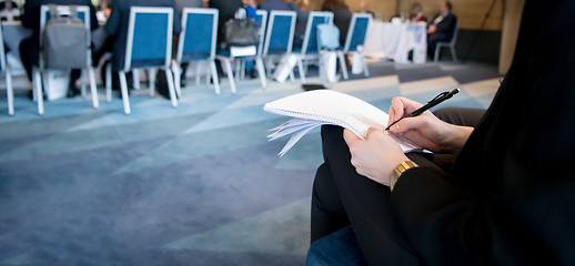 Image showing close up of business people taking notes