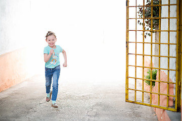 Image showing little girl running on the city streets