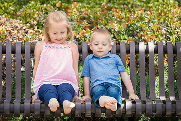 Image showing Young Sister and Brother Having Fun On The Bench At The Park