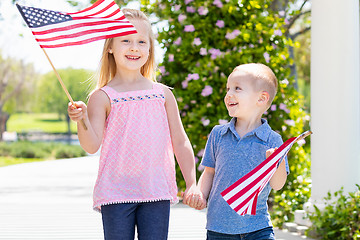 Image showing Young Sister and Brother Waving American Flags At The Park