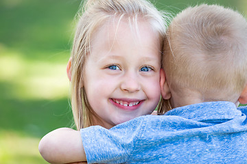 Image showing Young Brother and Sister Hugging At The Park