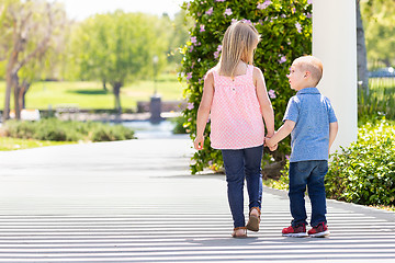 Image showing Young Sister and Brother Holding Hands And Walking At The Park