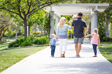 Image showing Young Caucasian Family Taking A Walk In The Park