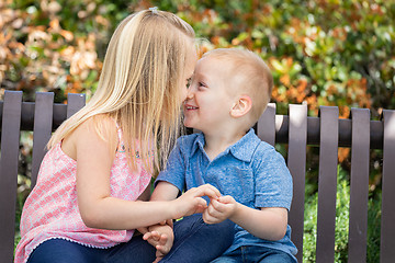 Image showing Young Sister and Brother Having Fun On The Bench At The Park