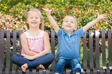 Image showing Young Sister and Brother Having Fun On The Bench At The Park