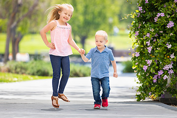 Image showing Young Sister and Brother Holding Hands And Running At The Park