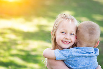 Image showing Young Brother and Sister Hugging At The Park