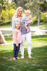 Image showing Happy Young Caucasian Mommy and Daughters Portrait In The Park