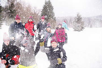 Image showing group of young people throwing snow in the air