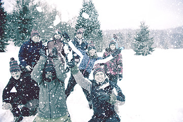 Image showing group of young people throwing snow in the air