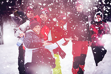 Image showing group portait of young people posing with snowman