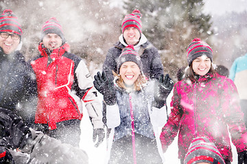 Image showing group of young people throwing snow in the air