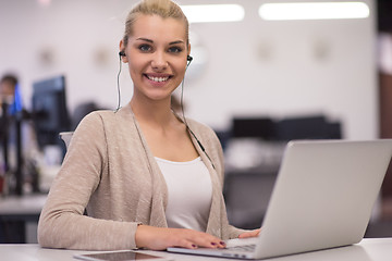 Image showing businesswoman using a laptop in startup office