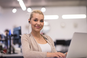 Image showing businesswoman using a laptop in startup office