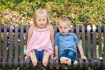 Image showing Young Sister and Brother Having Fun On The Bench At The Park