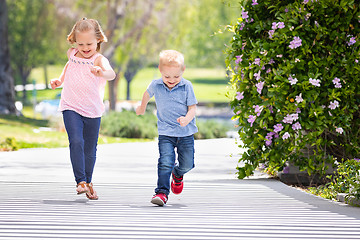 Image showing Young Sister and Brother Having Fun Running At The Park