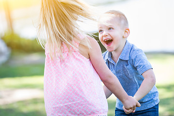 Image showing Young Brother and Sister Playing At The Park Togther
