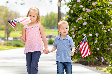 Image showing Young Sister and Brother Waving American Flags At The Park