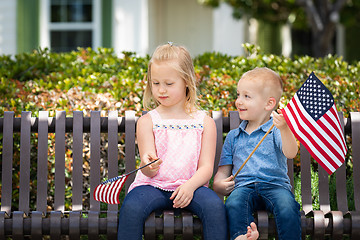 Image showing Young Sister and Brother Comparing Each Others American Flag Siz