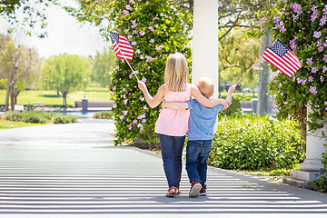 Image showing Young Sister and Brother Waving American Flags At The Park