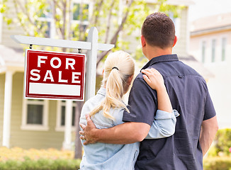 Image showing Caucasian Couple Facing Front of Sold Real Estate Sign and House