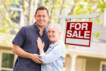 Image showing Caucasian Couple in Front of For Sale Real Estate Sign and House