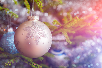 Image showing Christmas-tree decoration bauble on decorated Christmas tree bac