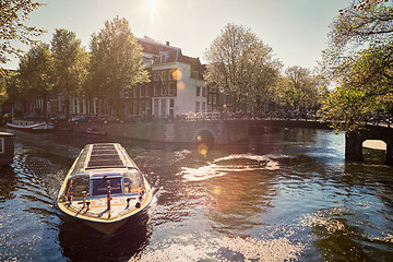 Image showing Amsterdam canal with tourist boat