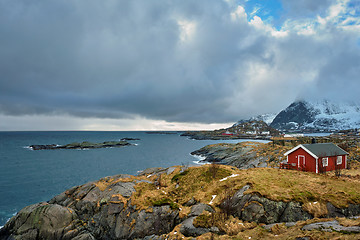 Image showing Clif with traditional red rorbu house on Lofoten Islands, Norway