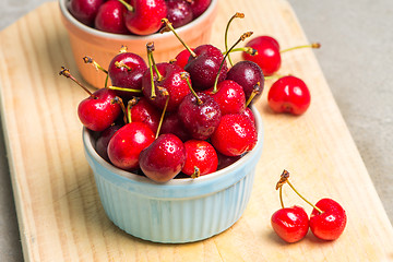 Image showing Red ripe cherries in ceramic bowls