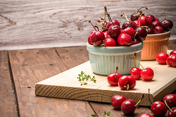 Image showing Red ripe cherries in ceramic bowls