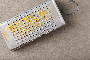 Image showing Metal scraper with lemon zest
