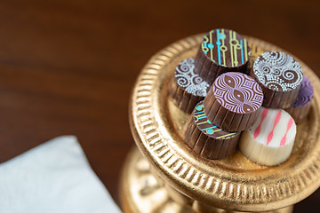 Image showing Artisan Fine Chocolate Candy On Gold Pillar Serving Dish