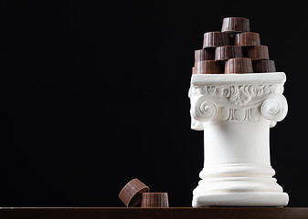 Image showing Stack of Fine Artisan Chocolates Stacked On White Pillar Column