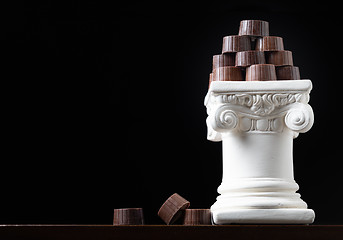 Image showing Stack of Fine Artisan Chocolates Stacked On White Pillar Column