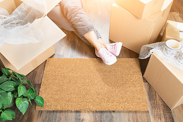 Image showing Woman Wearing Sweats Relaxing Near Home Sweet Home Welcome Mat, 