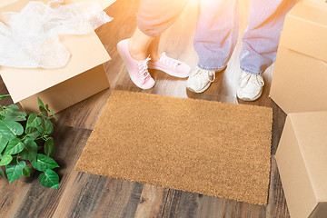 Image showing Man and Woman Standing Near Home Sweet Home Welcome Mat, Moving 