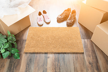 Image showing Home Sweet Home Welcome Mat, Moving Boxes, Women and Male Shoes 