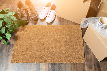 Image showing Home Sweet Home Welcome Mat, Moving Boxes, Women and Male Shoes 