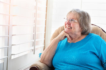 Image showing Content Senior Woman Gazing Out of Her Window
