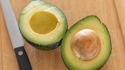 Image showing Fresh Cut Avocado on Wooden Cutting Board