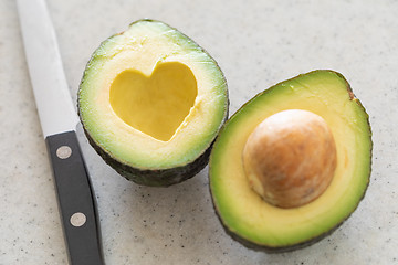 Image showing Fresh Cut Avocado With Heart Shaped Pit Area On Wooden Cutting B